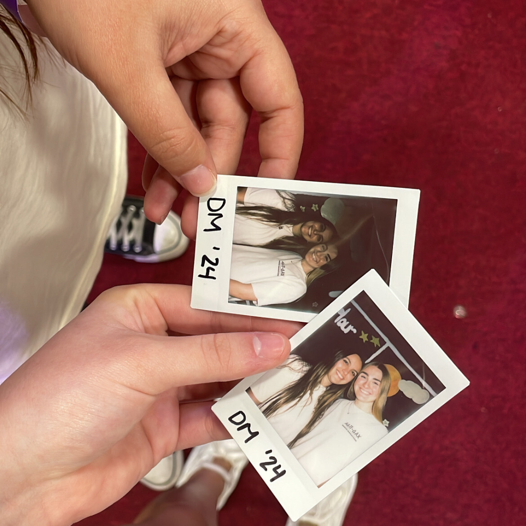 dance marathon poloroid pictures in hands from top view